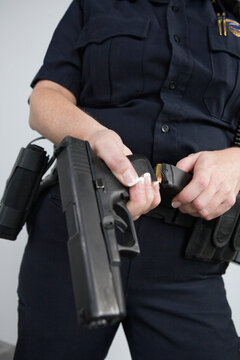 Police woman loading a pistol