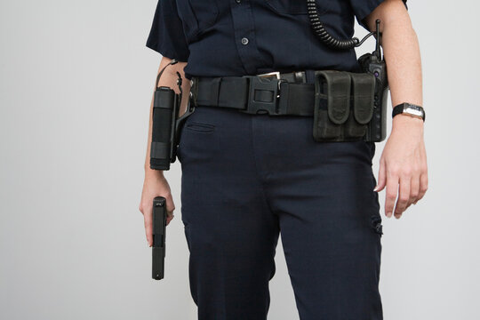 Police woman holding a loaded pistol ready to fire