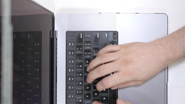 Overhead shot of person using a laptop keyboard for work or study