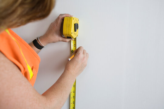 View of a woman using tape measure