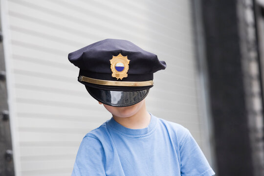 Boy wearing police cap