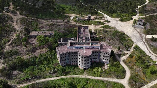 Drone shot of big abandoned building in the mountain.