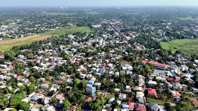 Wide cinematic aerial of Aluva featuring sprawling suburban communities, abundant vegetation, and open countryside pockets, highlighting the unique tropical character of this growing Kerala town.