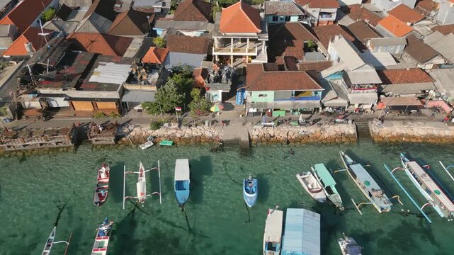 Houses Shops And Boats Benoa Bay Clear Blue Water Bali Indonesia Drone Track Left 4K 30FPS