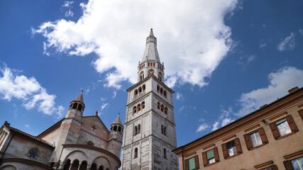 Fototapeta premium Ghirlandina (garland) tower, Modena, Emilia, Italy, UNESCO World Heritage Site, tower spire in the blue sky with clouds