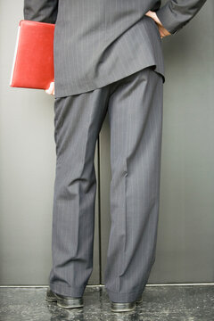 Low section view of a businessman waiting for the elevator