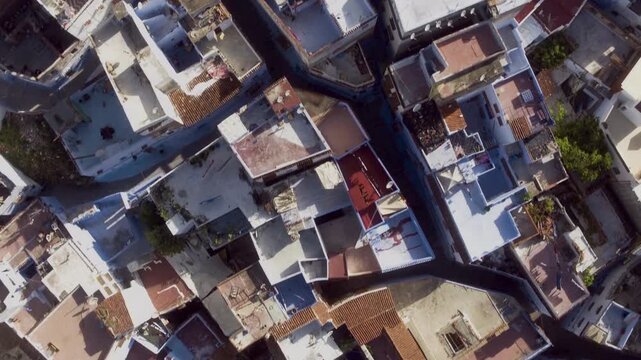 Drone pans overhead over dense Moroccan medina rooftops and narrow alleyways.