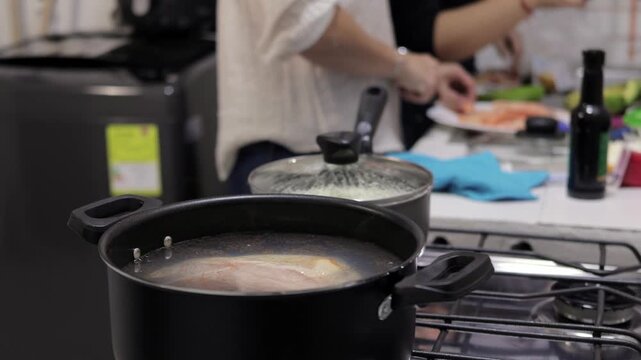 Pot simmering on stove during home meal preparation