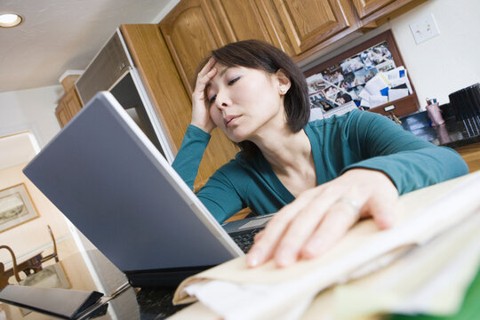 Low angle view of a mid adult woman using a laptop