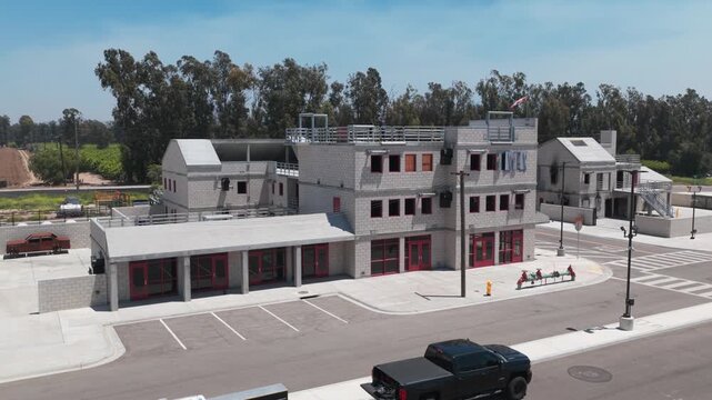 Low aerial push-in shot of a concrete burn building used for training at the Ventura County Fire Department training center in Camarillo, California. 4K