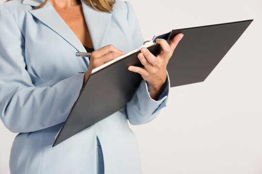 Business woman writing on a file