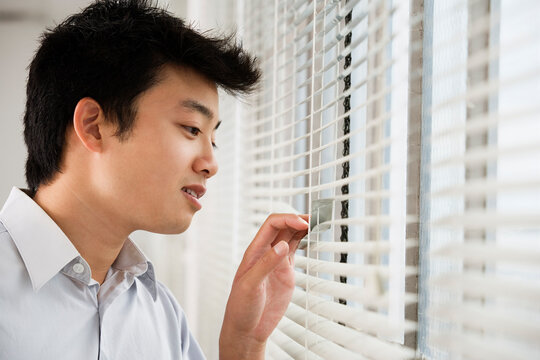 A man looking out from a window