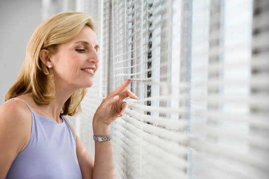 A business woman looking out from a window