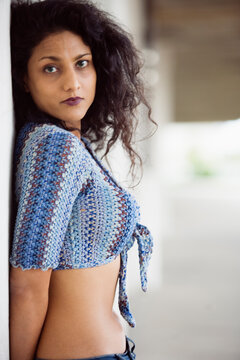 Portrait of a woman standing beside a wall