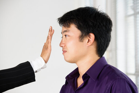 View of a hand stopping a man
