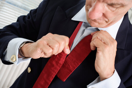 Close up of a mature man adjusting bowtie