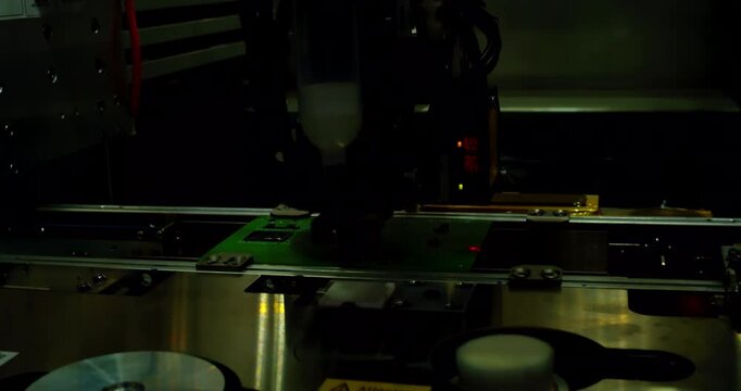 PCB moving on a conveyor belt during automated optical inspection. Flashing tech lights, macro close-up. Electronics manufacturing, smart factory, quality control and industry 4.0.