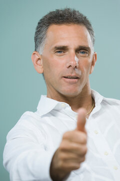 Portrait of a mid adult man showing a thumbs up sign