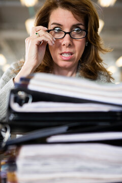View of a frustrated woman looking at files