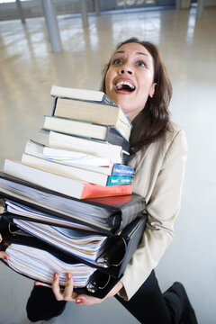 Business woman balancing the files while falling