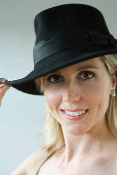 Portrait of a mid adult woman wearing a hat and smiling