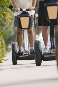 Two tourists riding segways