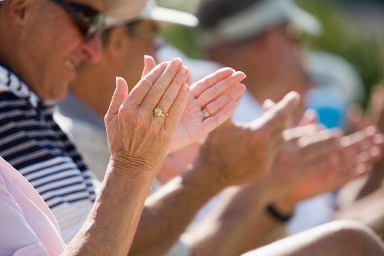 Senior spectators applauding