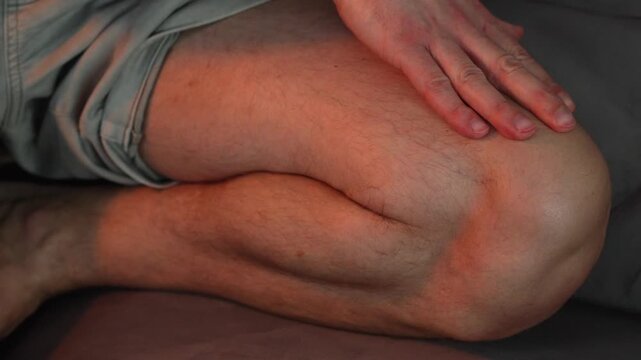 Massage the kneecap, kneading the leg to reduce pain from the injury