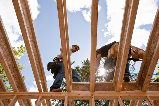 Carpenters working on second floor of a house