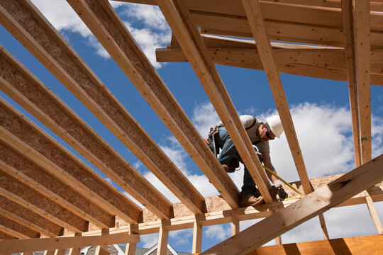 Carpenter working on second floor of a house