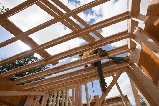 Worker constructing upper floor joists