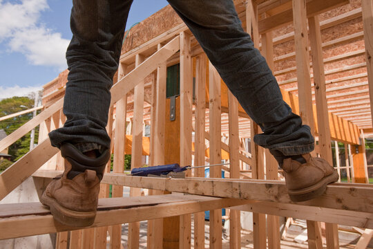 Carpenter balancing on upper floor