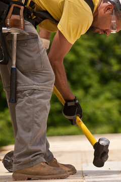 Carpenter using a sledgehammer