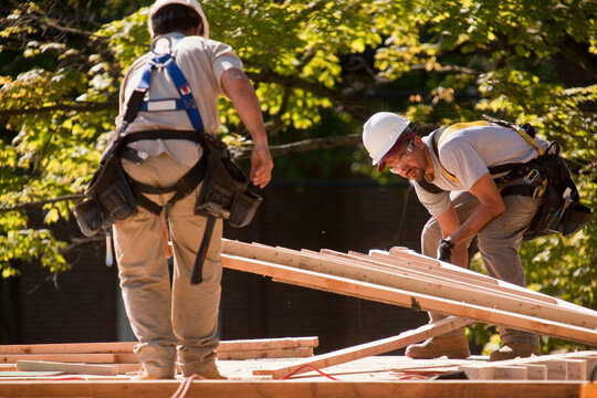 Carpenters picking a roofing gable at a construction site