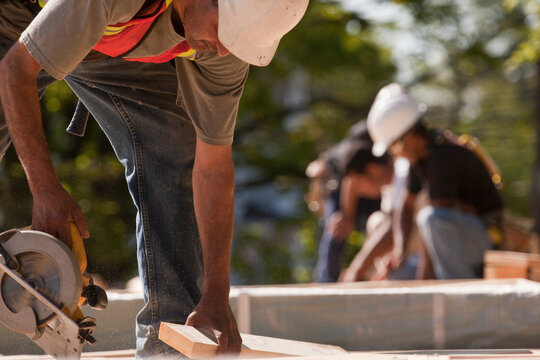 Carpenters using circular saw at a construction site