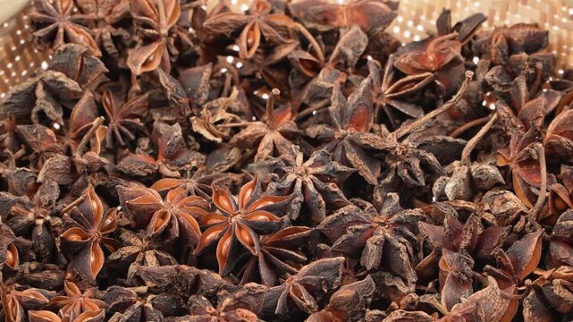 Close-up of premium dried star anise spices rotating slowly, creating a dense aromatic texture backdrop