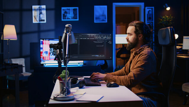 Programmer developing code on computer screen while in personal office using java programming languages. IT admin working with software tool, fixing database errors while working from home.