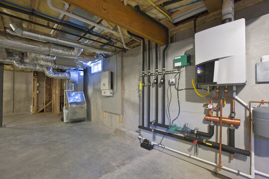 Heating and A/C system, photovoltaic inverter, and tankless hot water system in the basement of a