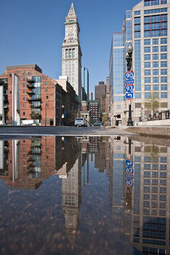 Custom House Tower reflected in a puddle at Rose Kennedy Greenway