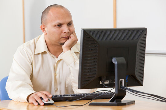 Engineering student studying computer display in a classroom
