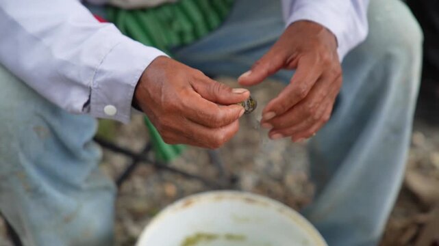 An angler intently preparing bait.