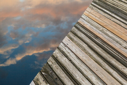 Reflection of clouds at sunset next to dock at Broadmoor Wildlife Sanctuary