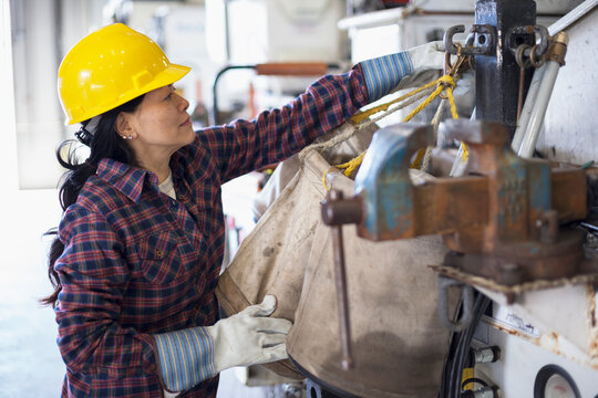 Female power engineer securing equipment on bucket truck