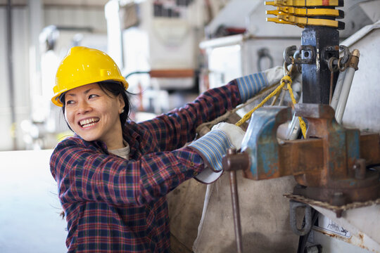 Female power engineer securing equipment on bucket truck