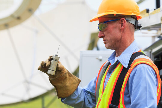 Communications engineer examining LNA pickup for satellite antenna