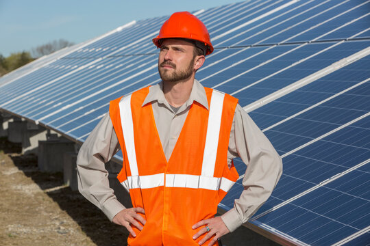 Power engineer standing at solar photovoltaic array