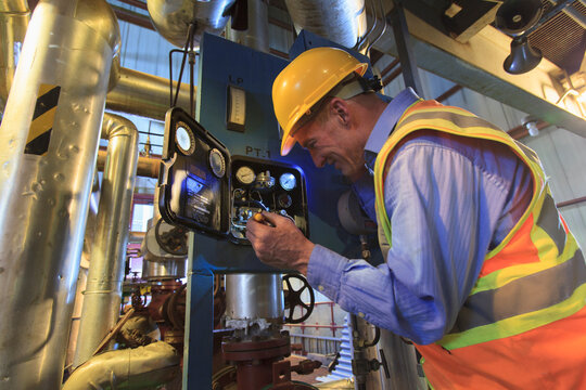 Engineer in electric power plant inspecting sensor