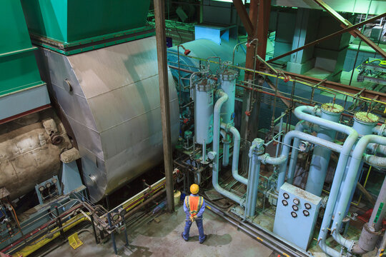 Engineer in gas turbine electric power plant exhaust gas and condensation process room