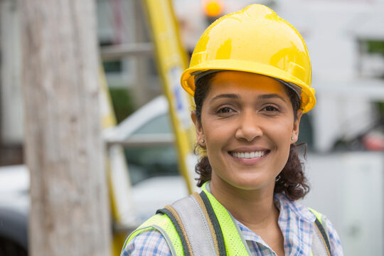 Portrait of happy Hispanic female utility worker smiling