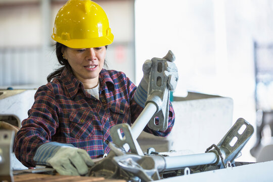 Female power engineer putting equipment into bucket truck
